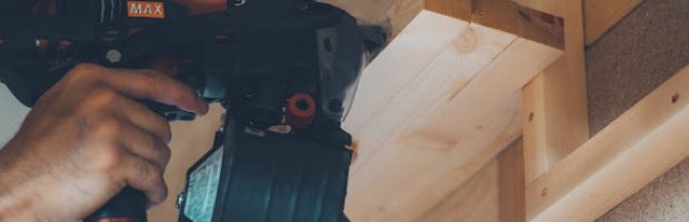 釘打機を木材に打ち付ける